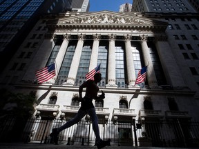 A jogger passes in front of the New York Stock Exchange on Wednesday.