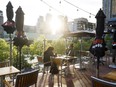 People sit on a patio along the waterfront in Toronto, on Wednesday, June 24, 2020.