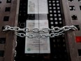 A chain secures locked gates in front of a shuttered store in Madrid, Spain.