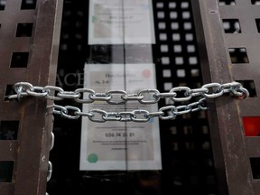 A chain secures locked gates in front of a shuttered store in Madrid, Spain.
