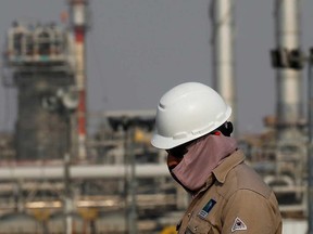 An employee looks on at Saudi Aramco oil facility in Abqaiq, Saudi Arabia.