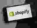The Shopify logo on a smartphone.