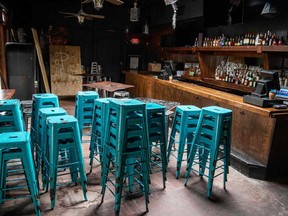 Chairs sit stacked inside a closed bar in Austin, Texas on Friday. Texas Governor Greg Abbott ordered bars to be closed by noon on June 26 and for restaurants to be reduced to 50 per cent occupancy. Coronavirus cases in Texas have spiked in recent weeks after being one of the first states to begin reopening.