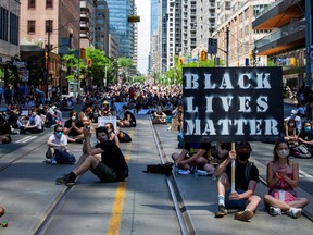 People take part in an "abolish the police sit in" to mark Juneteenth, which commemorates the end of slavery in Texas, two years after the 1863 Emancipation Proclamation freed slaves elsewhere in the United States, amid nationwide protests against racial inequality in Toronto.