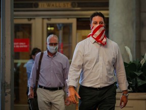 Traders exit the New York Stock Exchange at the end of a trading day in June.