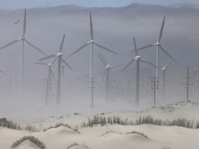 A wind farm operates with wind turbines as sand blows in the Coachella Valley on May 7, 2019 in Palm Springs, California.