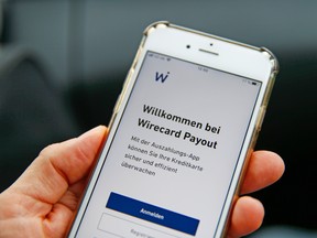 A welcome screen from the Wirecard AG Payout app sits on a mobile device in this arranged photograph in Munich, Germany, on Friday, June 19, 2020.