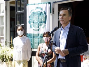 Minister of Finance Bill Morneau discusses the subsidy July 17 in front of a Toronto restaurant.