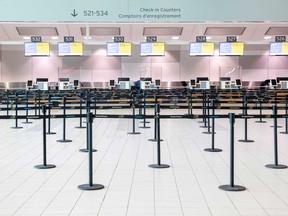 An empty check-in counter at Toronto Pearson International Airport in Toronto.