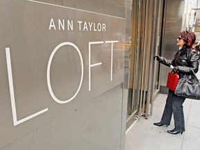 A shopper enters a Ann Taylor Loft clothing store located on Madison Avenue in New York City in 2006.