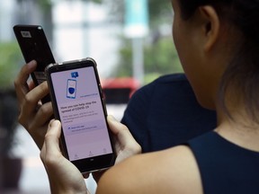 A woman uses a contract tracing app in Singapore.