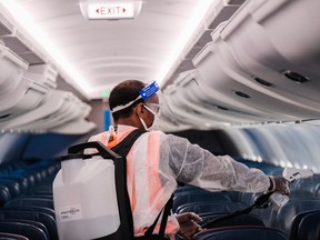 An airport employee performs an aircraft disinfecting demonstration during a media preview at the Ronald Reagan National Airport on July 22, 2020 in Arlington, Virginia.