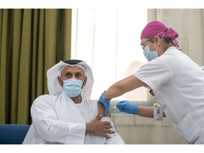 H.E. Sheikh Abdullah bin Mohammed Al Hamed, Chairman of Department of Health, Abu Dhabi, being administered the world's first clinical Phase III trial of inactivated vaccine to combat COVID-19