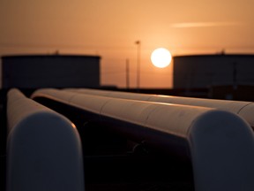 The sun rises beyond oil storage tanks at the Enbridge Inc. Cushing storage terminal in Cushing, Oklahoma, U.S.