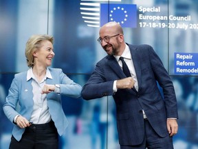 European Commission President Ursula Von Der Leyen and European Council President Charles Michel bump elbows at the end of the news conference following a four days European summit at the European Council in Brussels, Belgium.