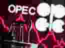 A 3D printed oil pump jack is seen in front of displayed stock graph and Opec logo in this illustration picture.