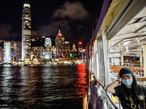 A woman wearing a face mask takes a Star Ferry in Victoria Harbour from Kowloon side to Hong Kong Island on July 27.