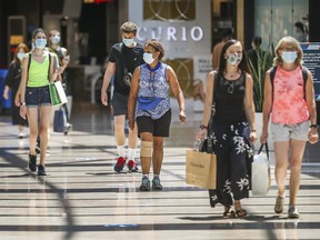 Shoppers wearing masks at a mall in Toronto. Canadians' perceptions of their personal finances remain gloomy.