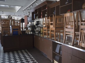 Chairs are seen on the counter of a closed restaurant in Whistler, B.C.