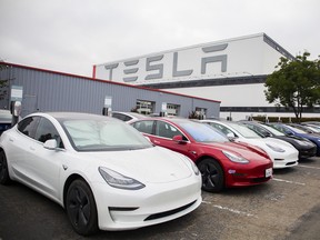 Tesla Inc. electric vehicles charge at the Tesla Supercharger station in Fremont, California.