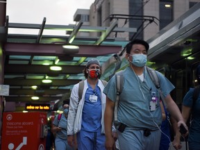 Health-care workers walk through the Texas Medical Center during a shift change as cases of the coronavirus disease (COVID-19) spike in Houston, Texas, in July.