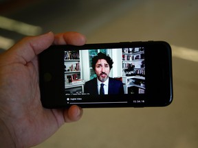 Prime Minister Justin Trudeau is seen on a mobile device speaking by video conference before the House of Commons standing committee in Ottawa, on Thursday, July 30, 2020.