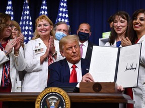 U.S. President Donald Trump signs an executive order on lowering drug prices at the White House, in Washington, D.C., on July 24, 2020.