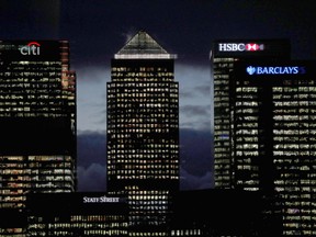 The financial offices of banks, including Barclays (R), Citi (L), and HSBC (2R), are pictured at dusk alongside One Canada Square (C) in the financial district of Canary Wharf, in London.