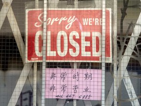 A closed sign on a Toronto store's front door during the Covid 19 pandemic.