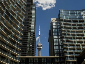 The CN Tower is framed by condo buildings in Toronto, Ont.