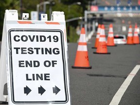 A sign reads "COVID-19 Testing End Of Line" outside a cornavirus testing site in a parking lot at Dodgers Stadium in Los Angeles, California.