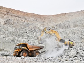 An excavator clears out rocks into a dumper at the gold mine, operated by Endeavour Mining Corporation in Hounde, Burkina Faso.