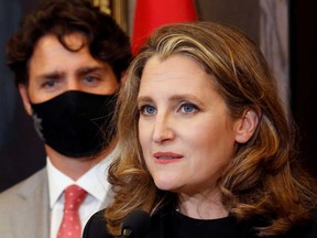 Deputy Prime Minister and Finance Minister Chrystia Freeland speaks to reporters next to Canadian Prime Minister Justin Trudeau on Parliament Hill in Ottawa Tuesday.