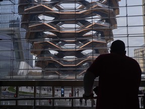 A visitor views the "Vessel" sculpture, by Thomas Heatherwick, at Hudson Yards on opening day in New York, U.S., on Friday, March 15, 2019.