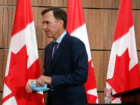 Bill Morneau leaves a news conference in Ottawa, Monday after resigning as finance minister.