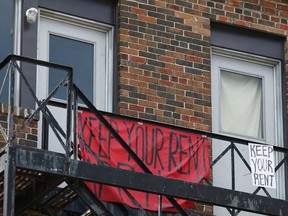 Signs calling for a rent strike hang from an apartment balcony during the coronavirus restrictions in Toronto in April. Ontario's moratorium on evictions was lifted in late July.