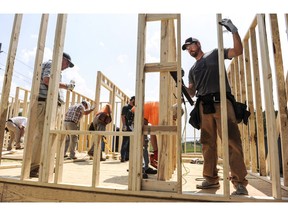 Workers build the frame of a Habitat for Humanity house as their United Way's Day of Caring project on Tuesday, Sept. 10, 2019, in Decatur, Ala. The head of a group that promotes charities says there are concerns about long-term negatives impacts in the sector from the ongoing WE controversy on Parliament Hill. THE CANADIAN PRESS/AP-Jeronimo Nisa/The Decatur Daily via AP)