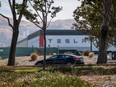 A Tesla Inc. vehicle drives past the company's assembly plant in Fremont, California.