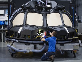 An employee inspects a Boeing Co. 787 cockpit shell and main instrument panel (MIP) at a CAE Inc. facility in Montreal, Quebec. Transportation will be a bright spot this year amid a bleak capital spending environment.