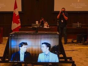 Marc Kielburger, screen left, and Craig Kielburger, screen right, appear as witnesses via videoconference during a House of Commons finance committee in Ottawa on Tuesday, July 28, 2020. The committee is looking into Government Spending, WE Charity and the Canada Student Service Grant.