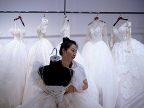 Ma Li, the owner of Hua Qing Yu Wedding Dress Store, says sales this year have not been good during the coronavirus disease outbreak, at Huqiu Wedding Dress Mall in Suzhou, Jiangsu province, China.
