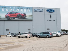 A parking lot with employees vehicles at the Ford assembly plant in Oakville, Ont., on Thursday, March 19, 2020.