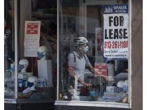 A lease sign hangs in the window as a cyclist walks past a commercial store Monday August 31, 2020 in Ottawa. The federal government is expanding the life of commercial rent-relief program one last time.