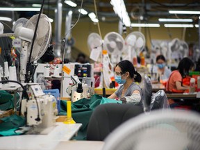 Workers at a manufacturing facility in Burnaby, B.C.