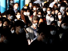 South Korean commuters wear protective masks as they crowd after getting off the subway during rush hour on September 15, 2020 in Seoul, South Korea.