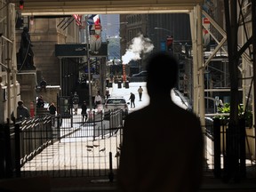 People walk in front of the New York Stock Exchange (NYSE) in lower Manhattan on September 21, 2020 in New York City.