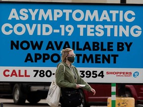 A sign advertises asymptomatic COVID-19 testing at a Shoppers Drug Mart in Edmonton. In provinces such as Alberta, pharmacists have become a critical part of the COVID-19 testing programs being rolled out to support the safe return to school.