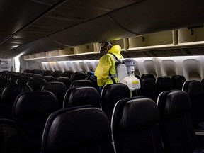 An employee disinfects an Air France plane at Charles de Gaulle international airport in May.