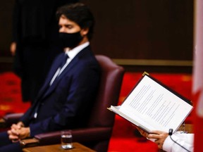 Canada's Governor General Julie Payette (hands and book), with Prime Minister Justin Trudeau, delivers the Throne Speech in the Senate on Wednesday.