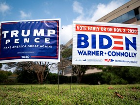 ard signs supporting U.S. President Donald Trump and Democratic U.S. presidential nominee and former Vice President Joe Biden are seen outside of an early voting site at the Fairfax County Government Center in Fairfax, Virginia, U.S., September 18, 2020.